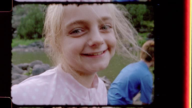 Retro style film footage of brother and sister testing the water and enjoying Black Rock Hot Springs on family camping trip.