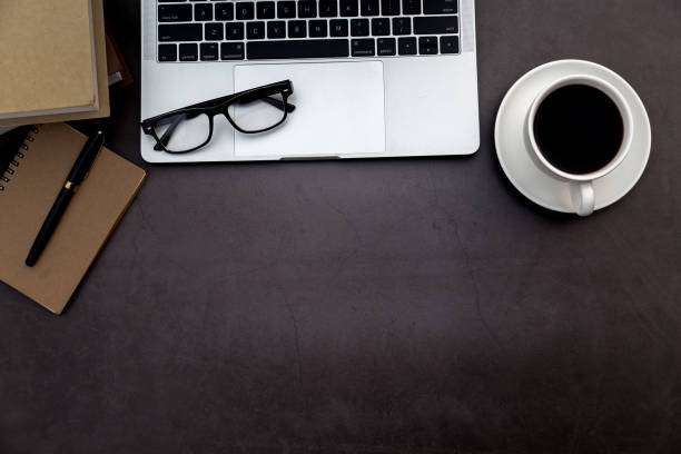 istock Workspace in office ,Black desk with blank notebook and other office supplies,Top view with copy space. 1138899743