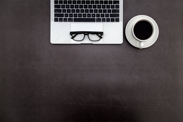 istock Workspace in office ,Black desk with blank notebook and other office supplies,Top view with copy space. 1138899748