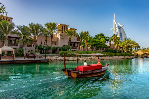 abra boat ride in souk medinat jumeirah Dubai,UAE 11. 03. 2018 : abra boat ride in souk medinat jumeirah with the burj al arab dubai stock pictures, royalty-free photos & images