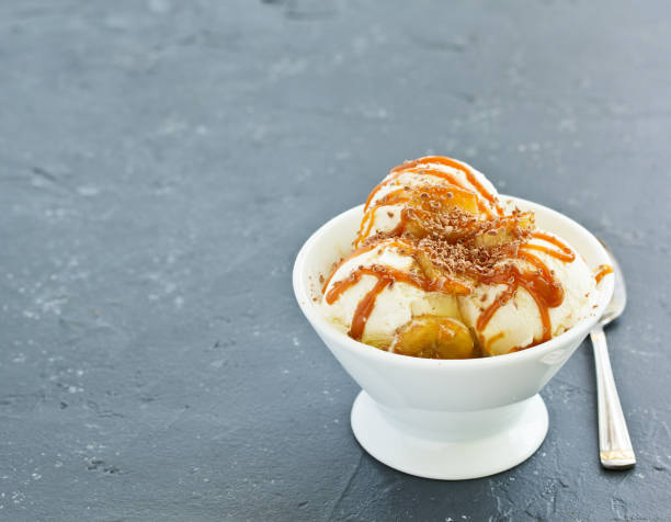 istock vanilla ice cream with bananas and caramel in a bowl. 1138901213