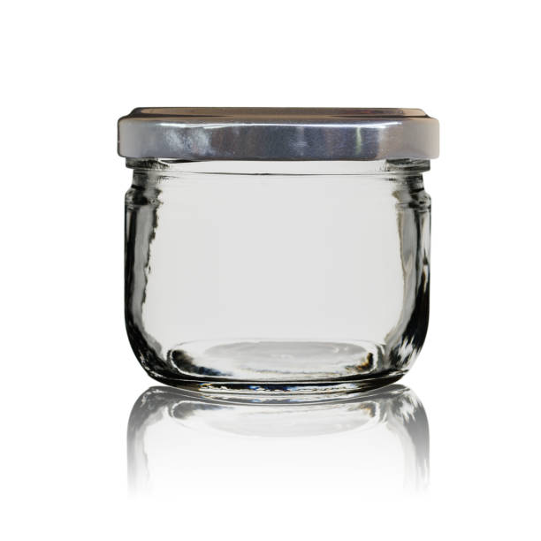 istock The empty glass jar closed by a cover with reflection. Isolated on a white background 1138901388
