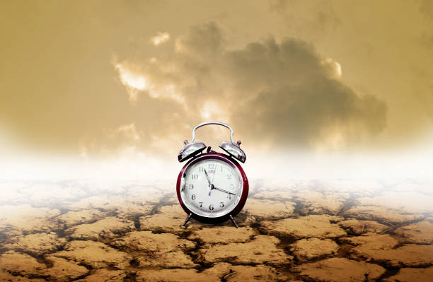 istock Time of adversity concept, Alarm clock with dry land background 1138909511