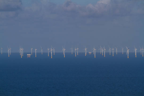 istock Offshore Wind Turbines out at sea from distance. 1138910640