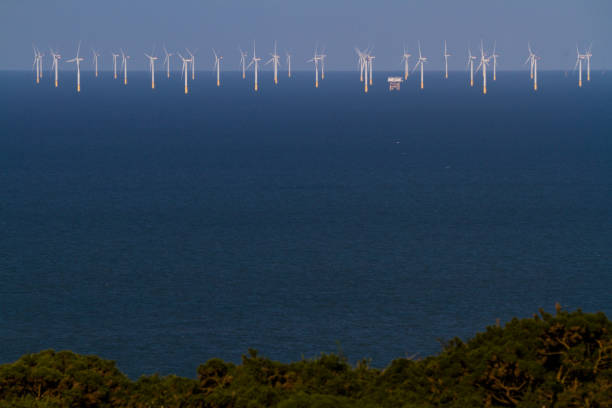 Wind Turbine farm at sea on sunny day, blue. Gwynt y Mor near Llandudno, North Wales, UK.