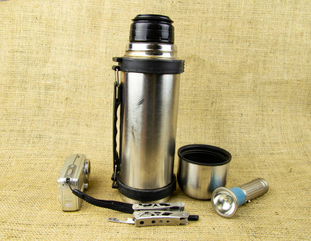 istock thermos with a cup - travel, tourist set 1138910747