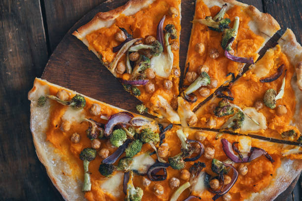 istock Preparing Vegan Pumpkin Pizza with Broccoli, Chickpeas and Spinach 1138910935