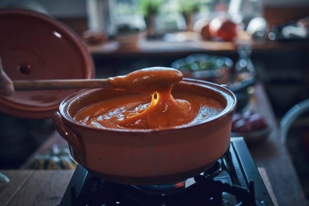 Preparing Pumpkin Soup in Domestic Kitchen Preparing Pumpkin Soup in Domestic Kitchen squash soup stock pictures, royalty-free photos & images