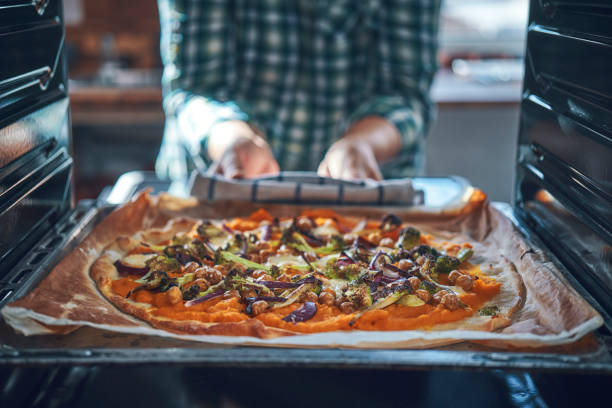 istock Preparing Vegan Pumpkin Pizza with Broccoli, Chickpeas and Spinach 1138910958