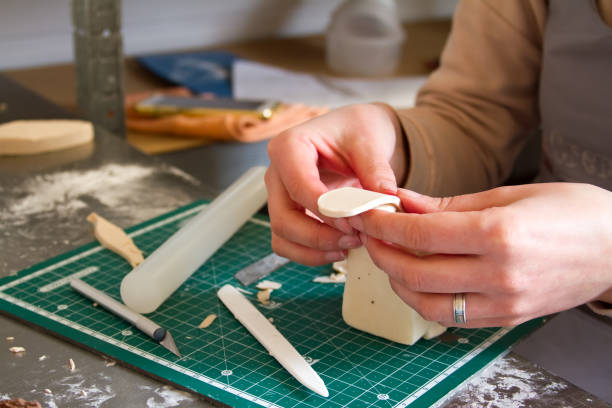 istock Confectionery decoration. Baker making wedding or birthday decorations and figurines from marzipan 1138911085