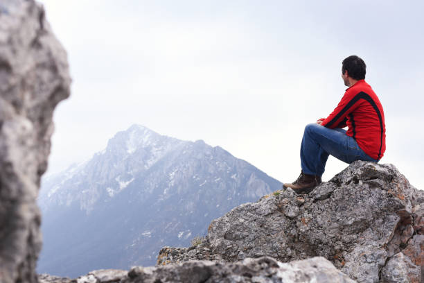 Young Man enjoy on top of the mountain