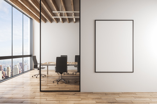 Modern meeting room interior with empty banner on concrete wall, furniture, wooden floor and panoramic city with sky view. 3D Rendering