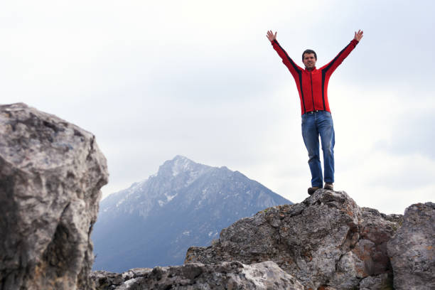 istock Man rise a hands on top of the mountain 1138913258