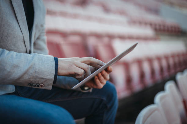 istock Close-up of a man using digital tablet at the stadium 1138913616