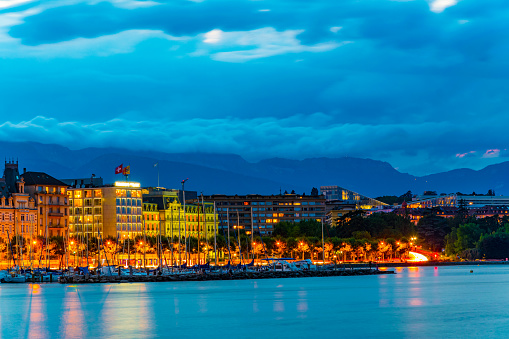 Sunset view of promenade stretched along historical buildings in Geneva, Switzerland