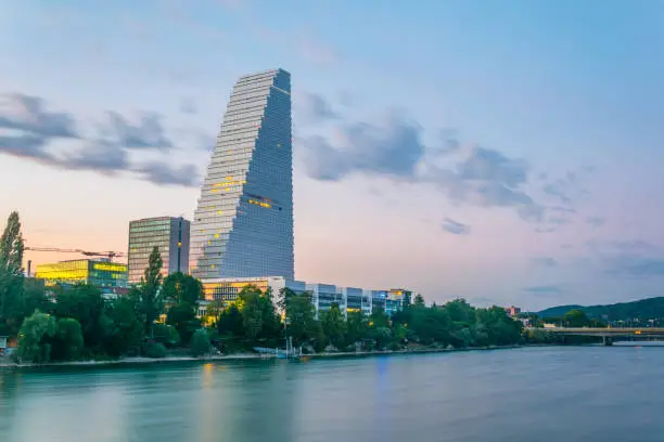 Sunset view of riverside of Rhine dominated by the Roche tower in Switzerland