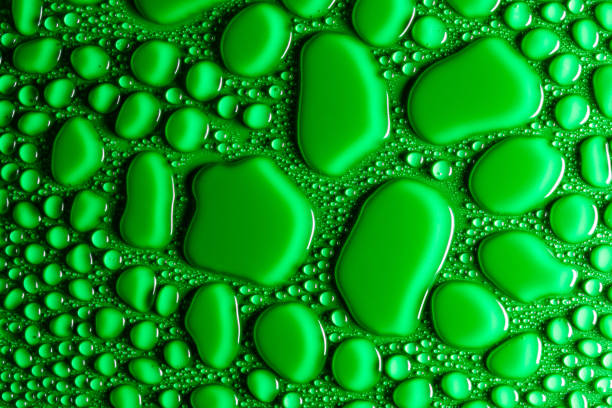 istock Droplets of water on a green, matte background illuminated with a delicate light. 1138916408