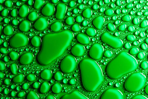 istock Droplets of water on a green, matte background illuminated with a delicate light. 1138916471