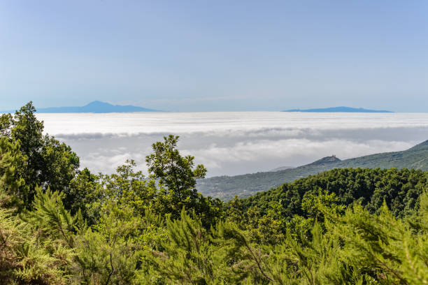 istock A landscape looking over a sea of clouds to two distant islands. 1138916828