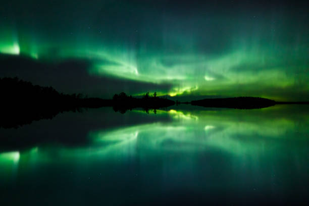 istock Beautiful northern lights over lake mirrored 1138916940