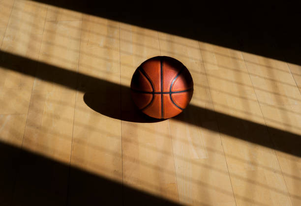 istock Basketball ball on the parquet with black background 1138919397