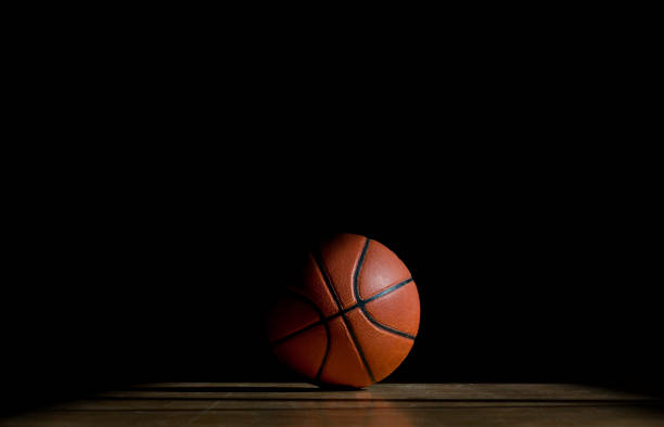 istock Basketball ball on the parquet with black background 1138919418