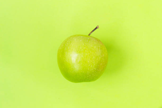 istock Green apple isolated on green background 1138919442