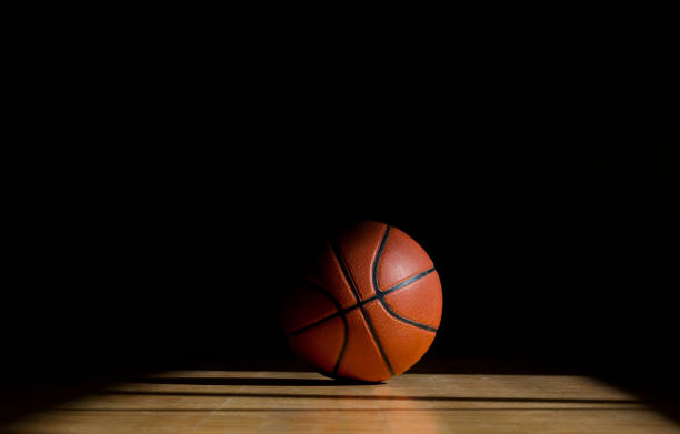 istock Basketball ball on the parquet with black background 1138919497