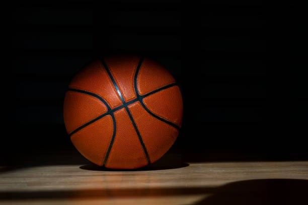 istock Basketball ball on the parquet with black background 1138919551