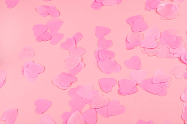 istock Pink background with heart-shaped confetti. 1138919937