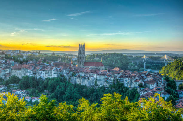 Sunset view over skyline of Fribourg, Switzerland Sunset view over skyline of Fribourg, Switzerland fribourg city switzerland stock pictures, royalty-free photos & images