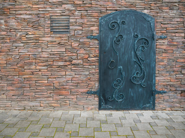Stone fortress, castle wall of a medieval castle, old wooden closed wrought door