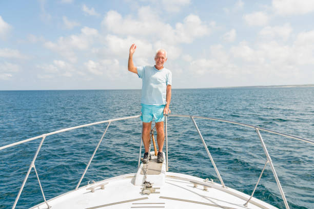 istock Senior man on the boat in Galapagos 1138925360