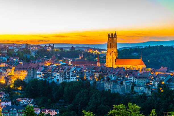 Sunset view over skyline of Fribourg, Switzerland Sunset view over skyline of Fribourg, Switzerland fribourg city switzerland stock pictures, royalty-free photos & images