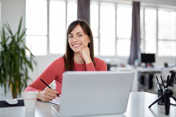 istock Woman using laptop in office. 1138927030