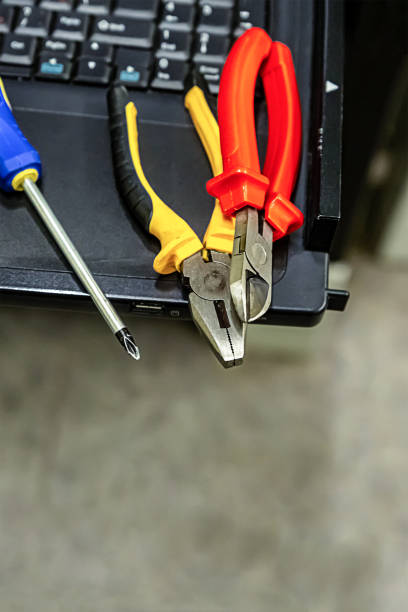istock repair laptop upgrade pliers screwdriver hand tools on computer keyboard backgroun 1138928791