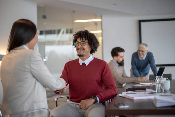 istock Multi-ethnic colleagues are shaking hands in a modern office 1138929573