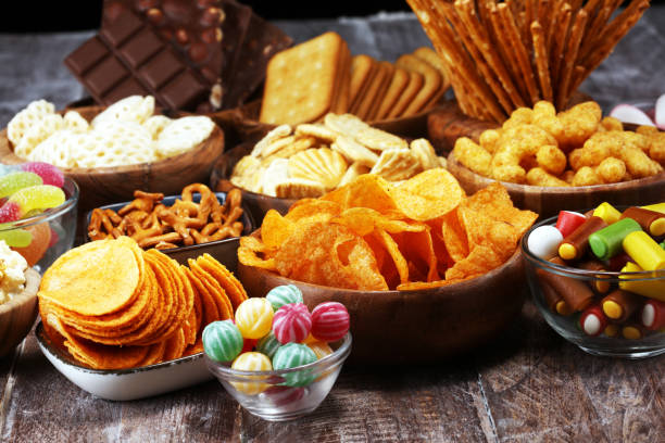 istock Salty snacks. Pretzels, chips, crackers in wooden bowls on table 1138930670