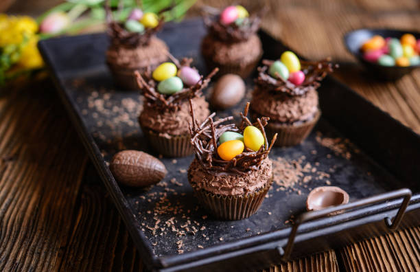 Easter nest cupcakes with chocolate whipped cream Easter nest cupcakes with chocolate whipped cream, decorated with colorful eggs easter cake photos stock pictures, royalty-free photos & images