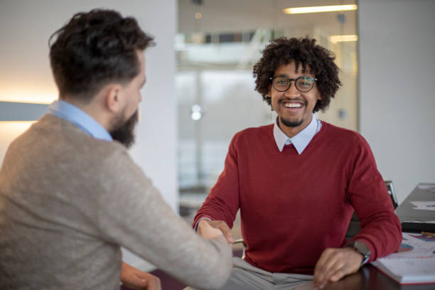 istock Multi-ethnic colleagues are shaking hands in a modern office 1138935778