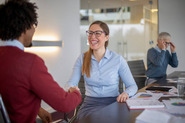 istock Multi-ethnic colleagues are shaking hands in a modern office 1138935885