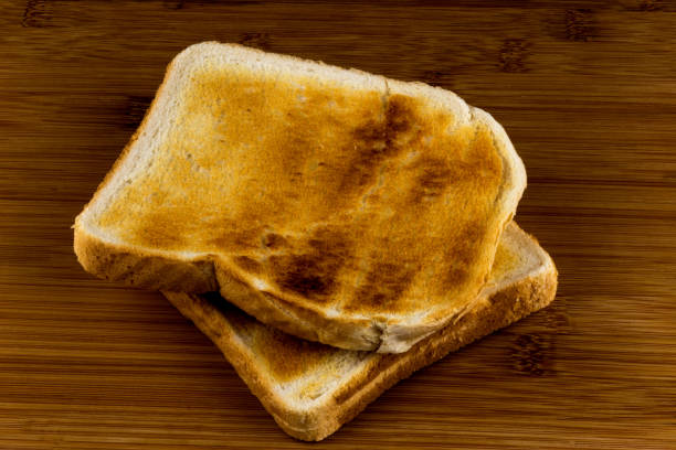 istock Toasted White Bread on a Wooden Surface 1138943782