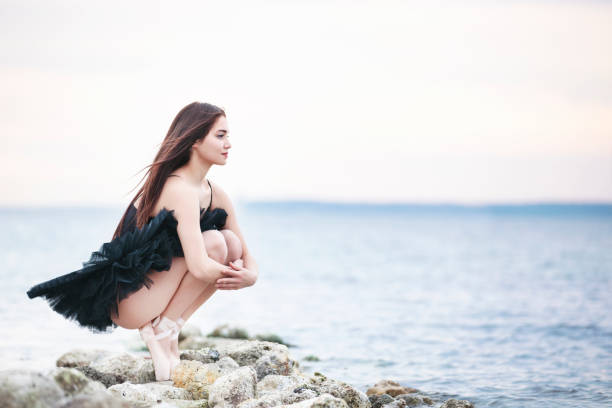 Beautiful ballet dancer looking away at outdoor