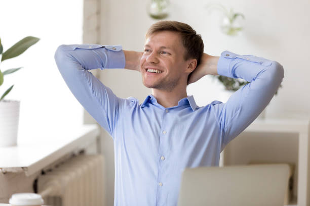 istock Man daydreaming with happy smile with hands clasped behind head 1138947268