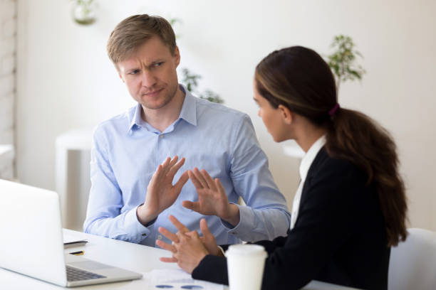 Millennial businessman rejecting giving interview to journalist Funny businessman rejecting to give interview to journalist. Stop sign. Man from recruitment management stopping interviewing lady, fraud, unhappy customer complaining, demanding compensation bossy stock pictures, royalty-free photos & images