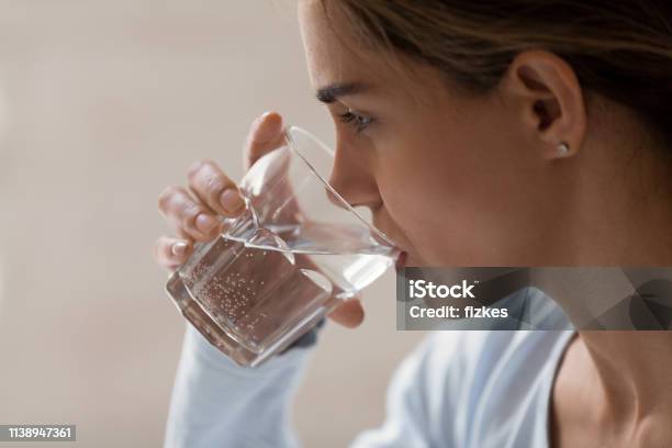 Closeup Profile Portrait Of Woman Drinking Pure Water From Glass Stock Photo - Download Image Now