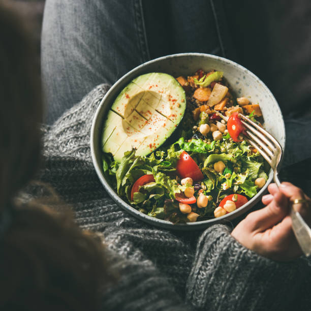 istock Woman holding bowl with vegetarian dinner, top view, square crop 1138948791