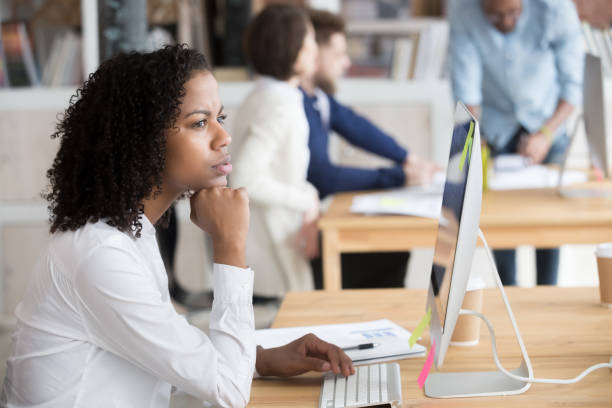 istock Serious black female employee thinking sitting in front of computer 1138949120