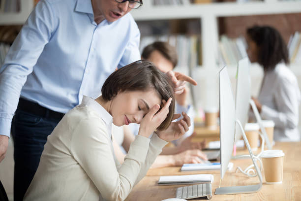 Angry irritated company ceo reprimanding employee female Angry irritated company boss reprimanding employee female, accusing of serious mistake and bad work. Young crying woman worker listening yelling from executive manager feels guilty frustrated unhappy harassment stock pictures, royalty-free photos & images