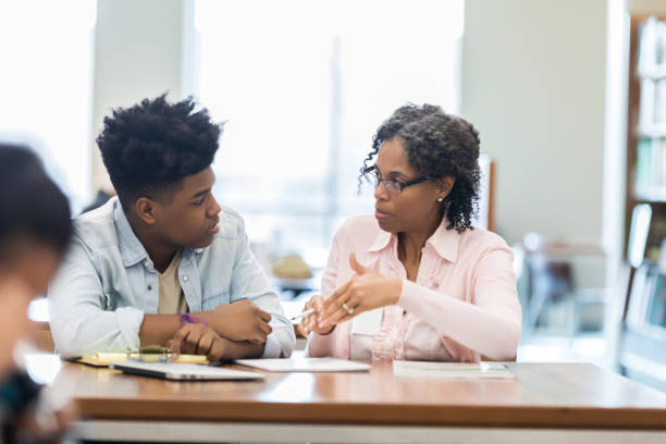 istock Retired teacher tutors high school student 1138949958